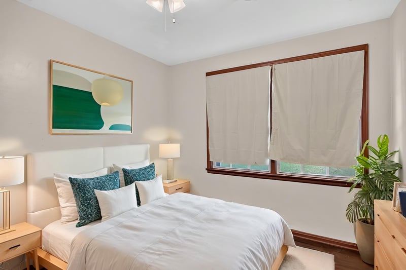 Bedroom staged with white bedding and wall art at 2132 Allandale Cir W, Jacksonville, FL