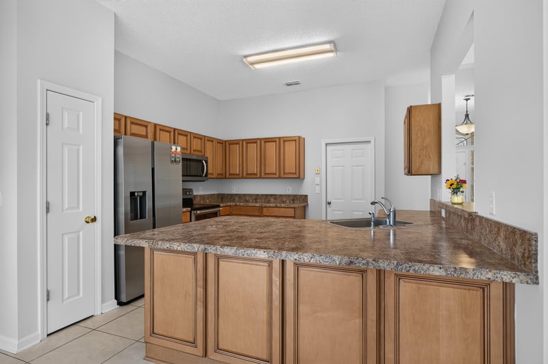 Kitchen island with breakfast bar seating at 456 Bay Point Way N, Jacksonville, FL 32259