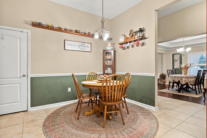 Breakfast nook with round table and pendant light at 10923 Black Diamond Ct, Jacksonville, FL