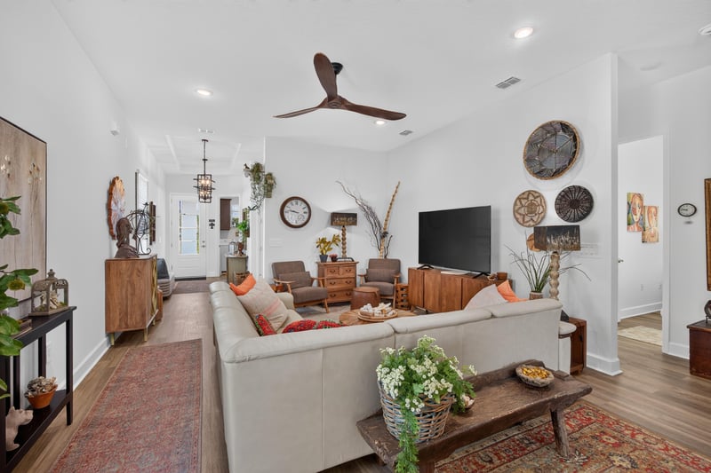 Living room seating area with sofa and accent chairs at 129 Amberwood Dr, St. Augustine, FL
