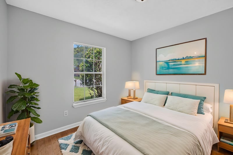 Bedroom with staged bed and framed art at 456 Bay Point Way N, Jacksonville, FL 32259