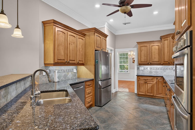 Kitchen with double wall ovens and granite counters at 1735 Hagans Ridge Ct
