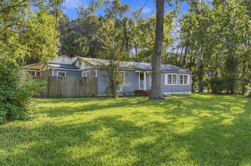 Front exterior angled view through trees at 1807 Idlewild Ave, Green Cove Springs, FL