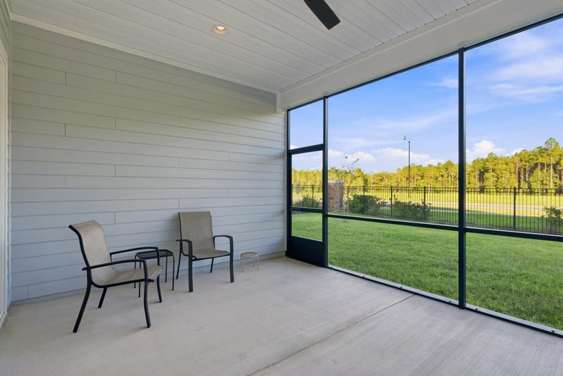 Covered lanai with seating and screened enclosure at 27 Holly Rdg Wy, St. Augustine, FL