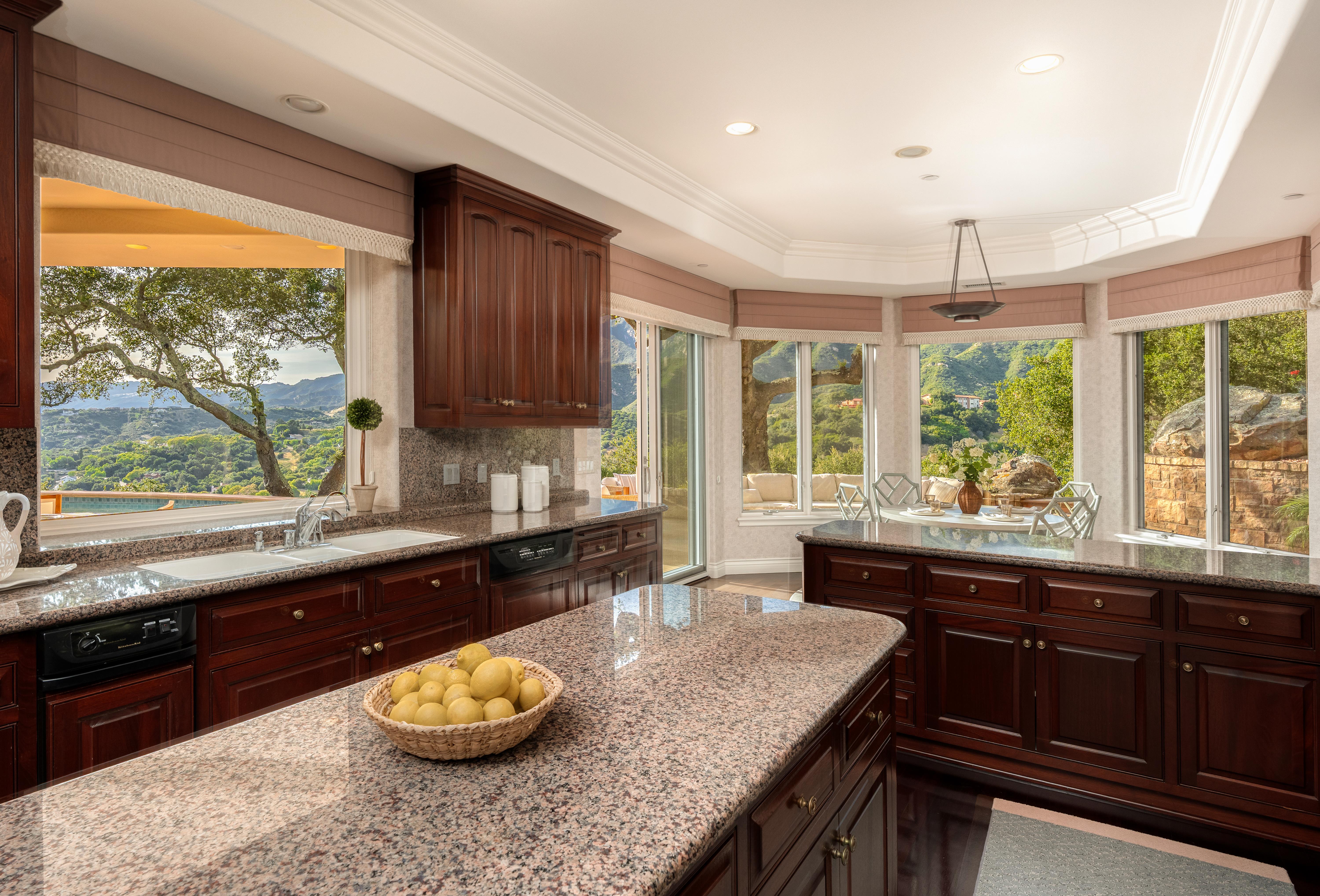 Exterior facade of luxury estate at 450 El Cielito Rd, Santa Barbara — professional real estate photography showcasing Santa Ynez Mountain views and architectural detail along the Santa Barbara Riviera. Our team captured still photography, aerial drone photography, twilight photography, a Matterport virtual tour, a 2D floor plan, and a custom property website from afternoon through twilight.
