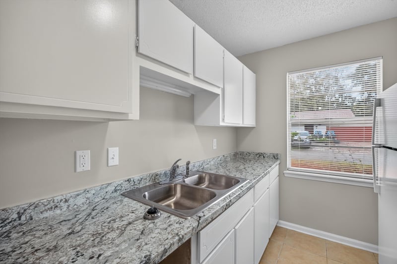 Kitchen with white cabinets and window at 1040 Willow Cove Ct E, Jacksonville, FL 32233