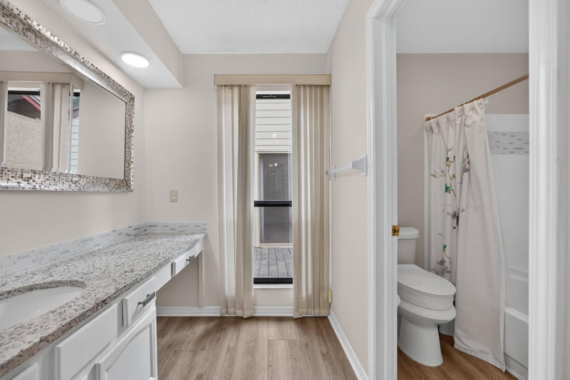 Bathroom with granite vanity and shower at 3407 Fairbanks Grant Rd N, Jacksonville, FL 32223