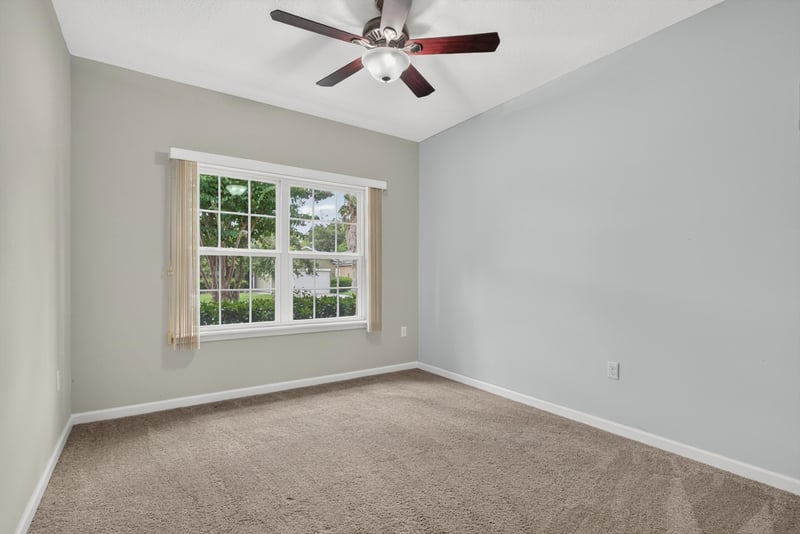 Carpeted bedroom with ceiling fan and window at 2378 Caney Oaks Dr, Jacksonville, FL