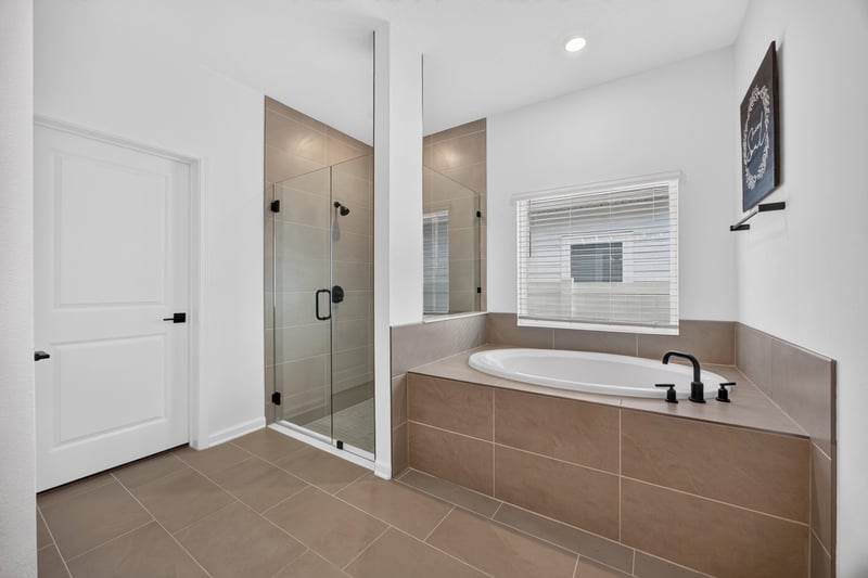 Primary bathroom with soaking tub and glass shower at 2354 Jennings Farm Dr, Middleburg, FL 32068