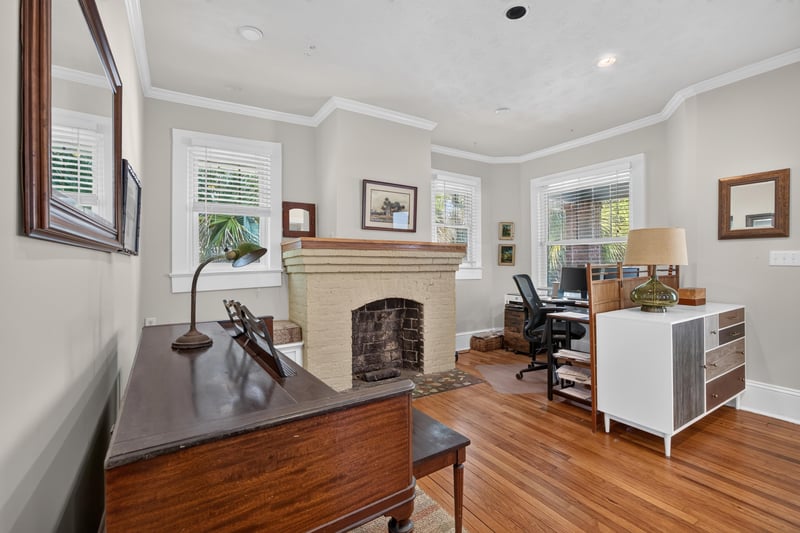 Living room with upright piano and fireplace mantel at 1555 Belmonte Ave, Jacksonville, FL 32207