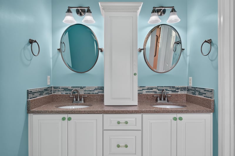 Primary bathroom with double vanity and teal tile at 1955 GUARDED Way, Fleming Island, FL 32003