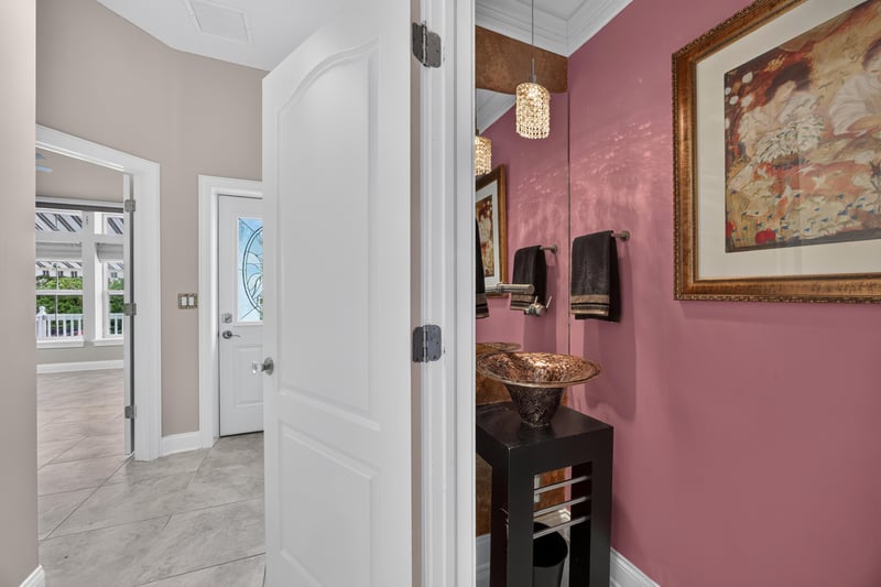 Bathroom with pink wall and vessel sink at 117 Island Cottage Way, St. Augustine, FL 32080