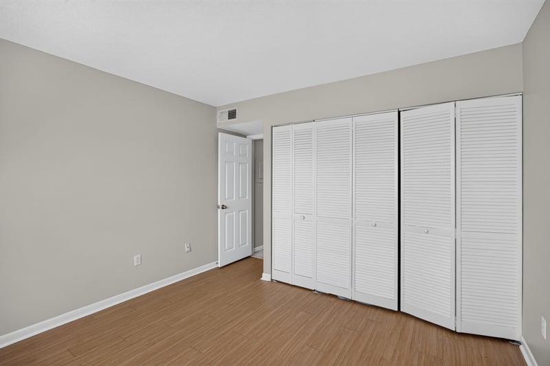 Bedroom with louvered closet doors at 700 W Pope Rd unit h61, St. Augustine, FL 32080