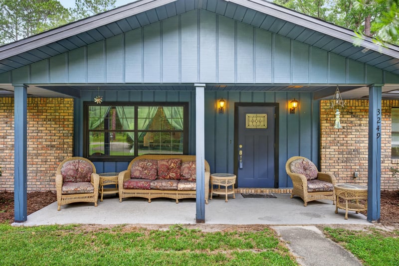 Covered front porch with wicker seating at 3249 Maryland Ave, Green Cove Springs, FL