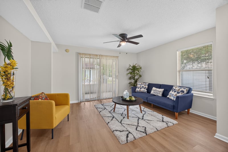Living room with sliding glass doors and area rug at 605 N Covered Bridge Rd, Jacksonville, FL