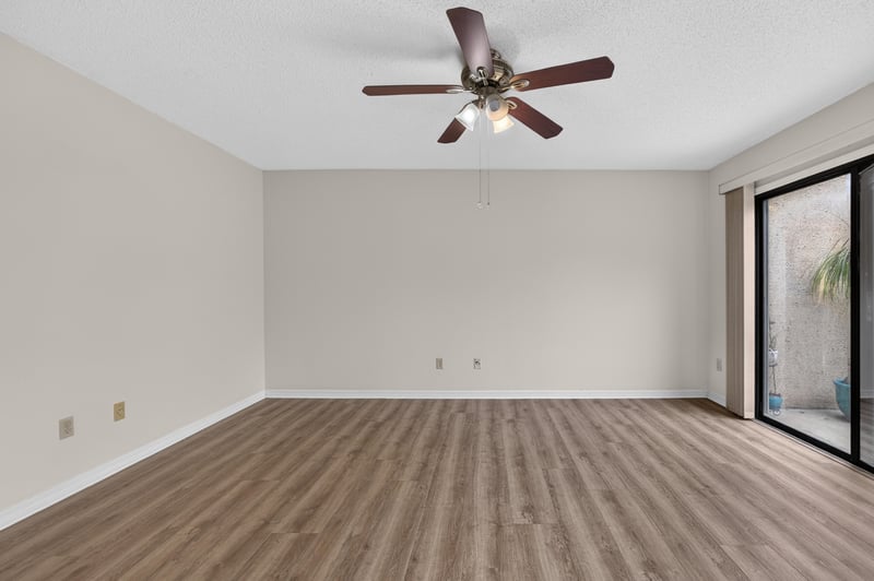 Bedroom with wood-look floors and sliding door at 3407 Fairbanks Grant Rd N, Jacksonville, FL 32223