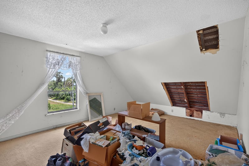 Bedroom with window and stored items at 1173 US-17, Satsuma, FL 32189