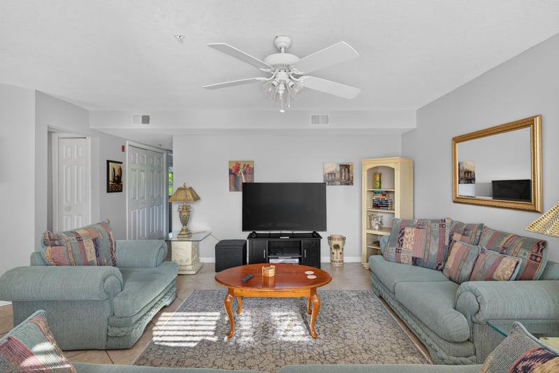 Living room with sofas and coffee table on area rug at 206 16th St, St. Augustine, FL 32080