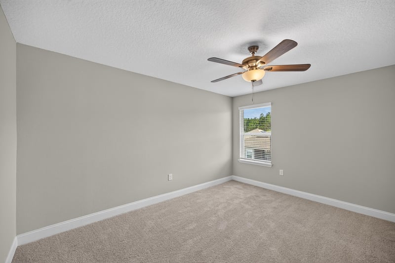Primary bedroom with carpet and window at 331 Millerstone Dr, St. Augustine, FL 32092