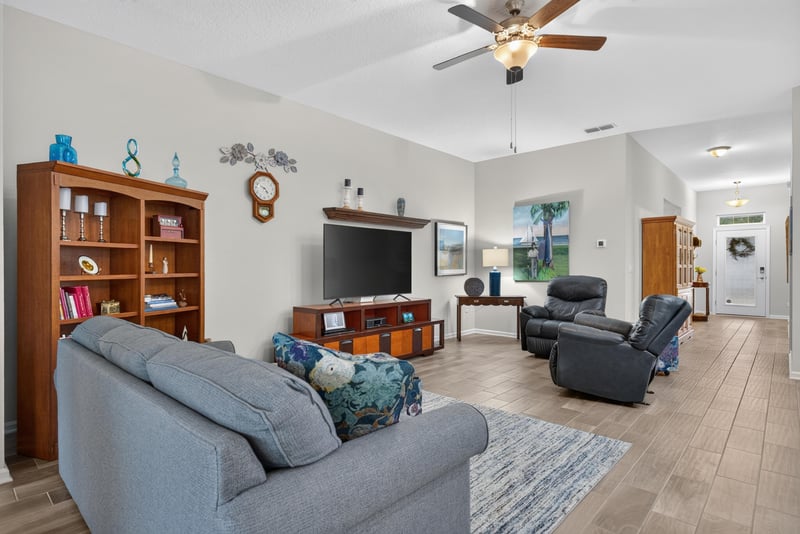 Living room with ceiling fan and sofa at 4319 Green River Pl, Middleburg, FL 32068