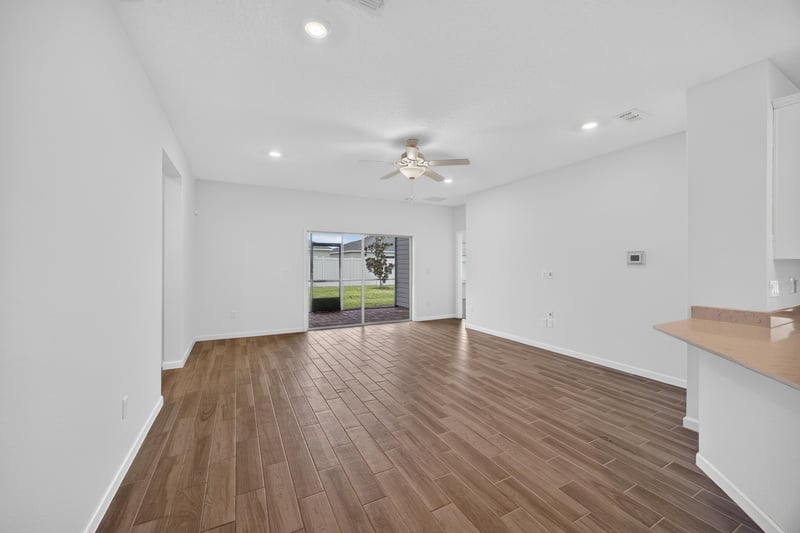 Living area with ceiling fan and wood-look flooring at 9905 Ansley Lake Dr, Jacksonville, FL