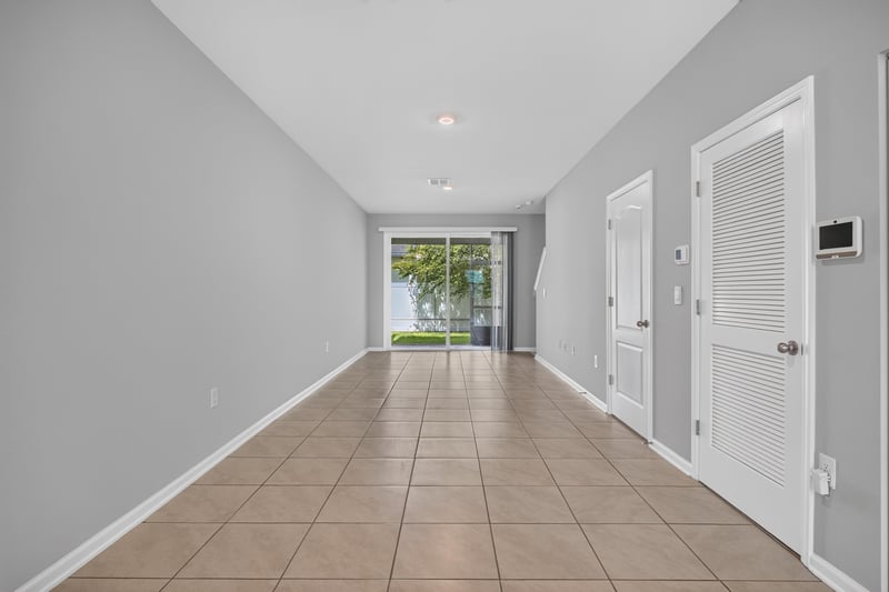 Hallway toward front door with tile floor at 2837 Black Buck Cir, Jacksonville, FL 32225