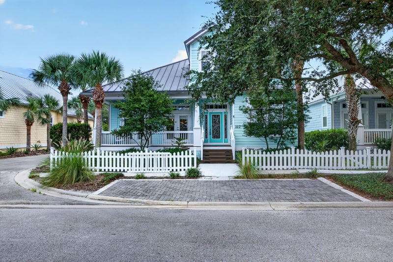 Front exterior corner view with picket fence at 117 Island Cottage Way, St. Augustine, FL 32080