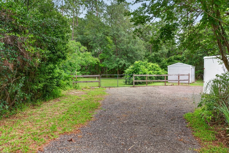 Gravel driveway leading through wooded lot at 3249 Maryland Ave, Green Cove Springs, FL