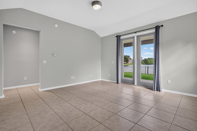 Living room with sliding door and curtains at 13685 Goodson Pl, Jacksonville, FL 32226