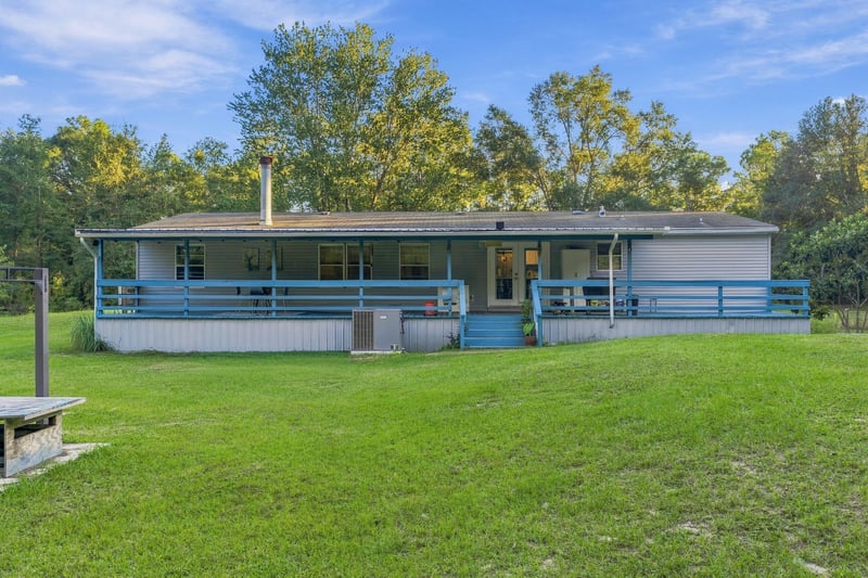 Rear exterior and yard, photographed by Megapixeler on Secret Cove Rd, Middleburg, FL