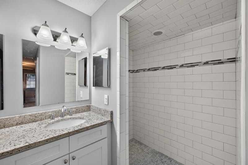 Bathroom vanity and walk-in tiled shower at 12344 Cormorant Ct, Jacksonville, FL