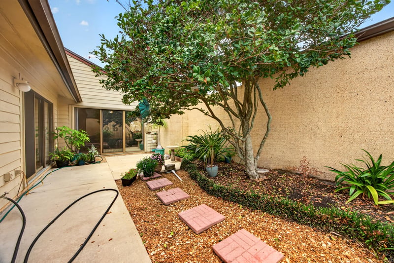 Courtyard patio with stepping stones and plants at 3407 Fairbanks Grant Rd N, Jacksonville, FL 32223