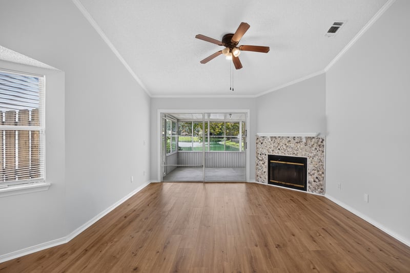 Living room with ceiling fan and windows at 8047 Mactavish Way E, Jacksonville, FL 32244