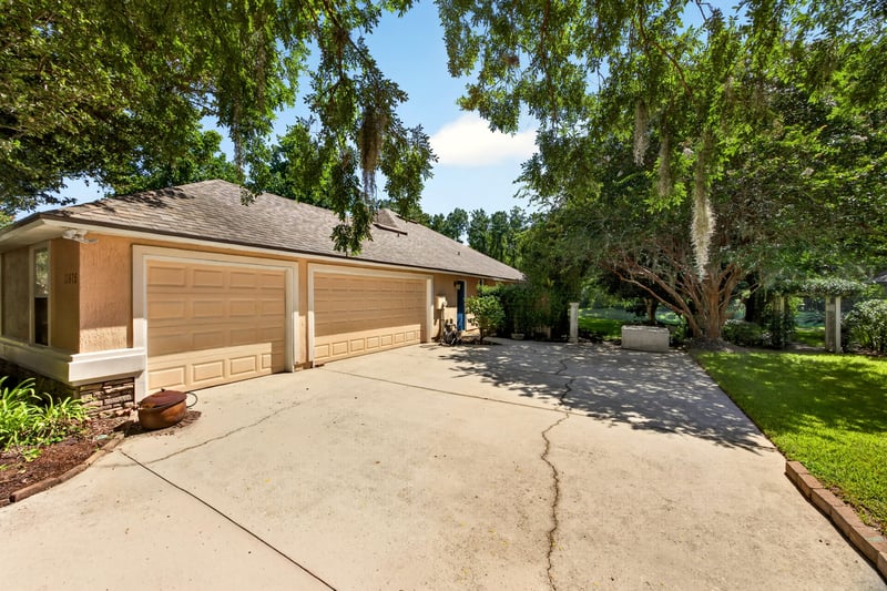 Front exterior and driveway toward the garage at 11675 Magnolia Estates Rd, Jacksonville, FL 32223