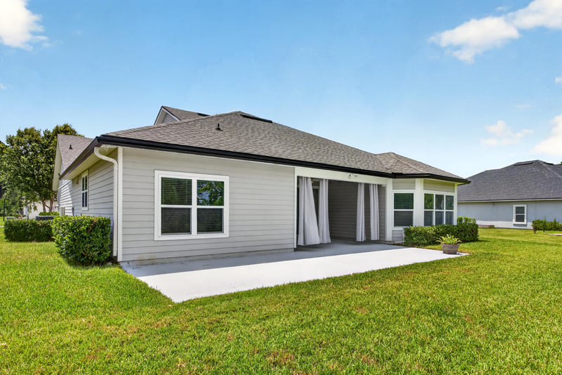Rear exterior view of covered patio and yard at 53 Lumen Ct, St. Augustine, FL 32095