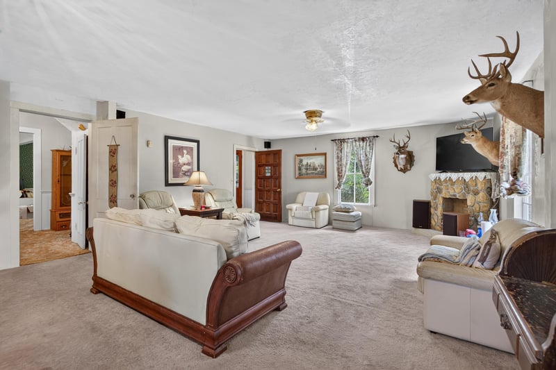 Living room with sleigh-style sofa and fireplace at 1173 US-17, Satsuma, FL 32189