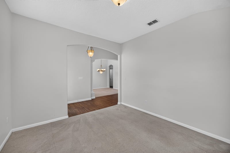 Hallway with carpet and arched doorway at 2480 Ridge Will Dr, Jacksonville, FL 32246