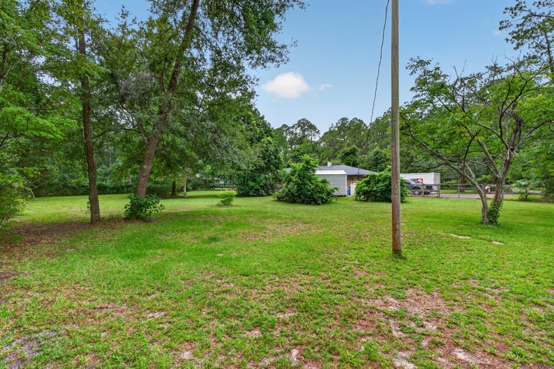 Open lot view with utility pole and trees at 3249 Maryland Ave, Green Cove Springs, FL