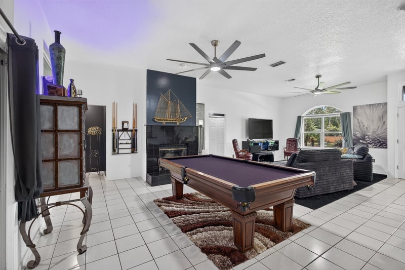 Living room with pool table and ceiling fan at 1346 Gately Ct, Jacksonville, FL 32225