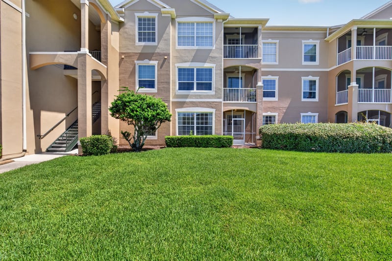 Condo building exterior with lawn at 7990 Baymeadows Rd E #404, Jacksonville, FL 32256