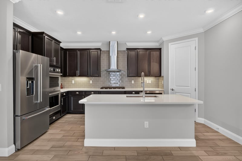 Kitchen island, range hood and tile backsplash at 91 Tilloo Ct, St. Johns, FL