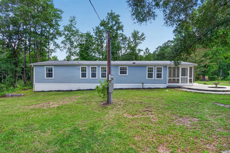 Front exterior view of home with power line at 4890 McAllister Rd, Middleburg, FL 32068