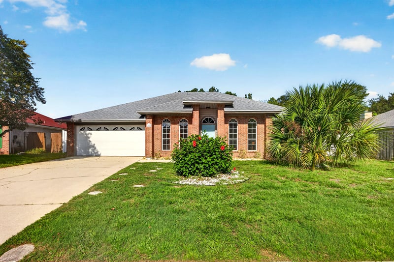 Front exterior with lawn and landscaping at 11828 Heather Grove Ln, Jacksonville, FL
