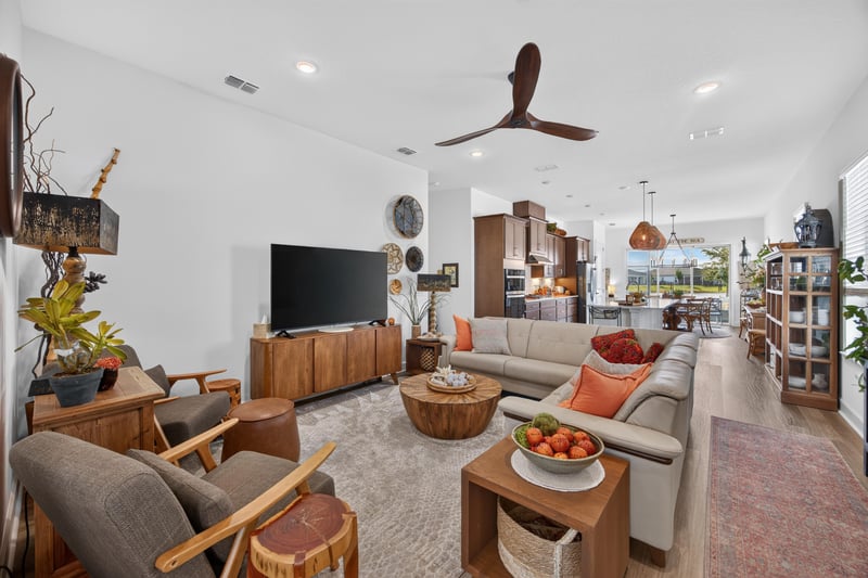 Living room open to kitchen with ceiling fan at 129 Amberwood Dr, St. Augustine, FL
