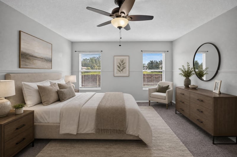 Staged primary bedroom with bed and nightstands at 7545 Lirope St, Jacksonville, FL 32244