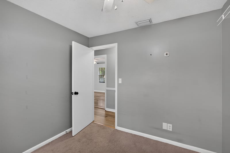Hallway closet area with wood-look flooring at 6757 Deer Springs Rd, Keystone Heights, FL 32656