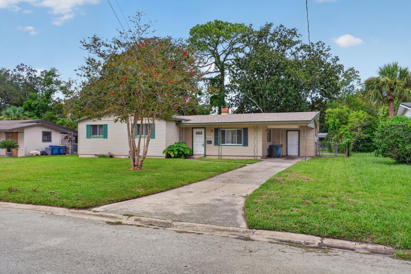 Front exterior with driveway and trees at 2618 Arlex Dr E, Jacksonville, FL