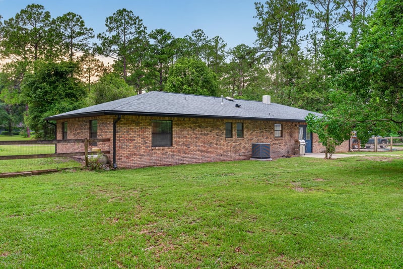 Backyard view with brick home and open lawn at 3249 Maryland Ave, Green Cove Springs, FL