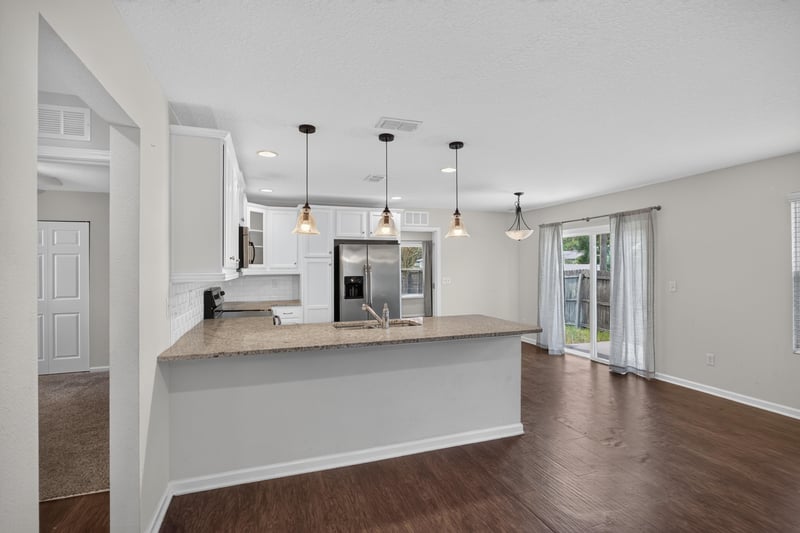 Kitchen peninsula with pendant lights and sliding door at 1002 Ingleside Ave, Jacksonville, FL 32205