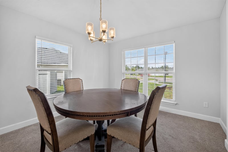 Dining area with round table and chandelier at 9846 Olivia St, Jacksonville, FL